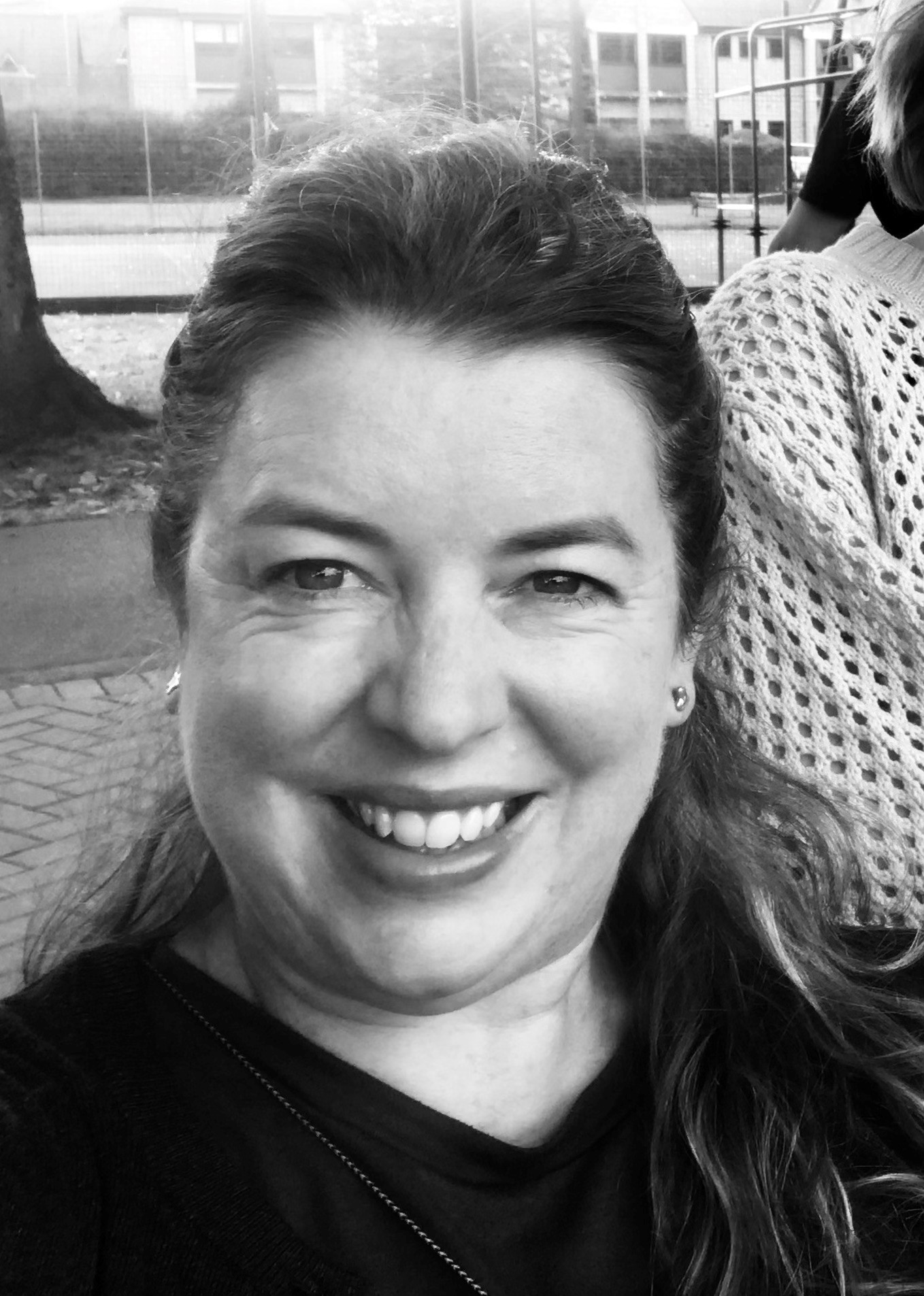 a black and white image of a woman smiling