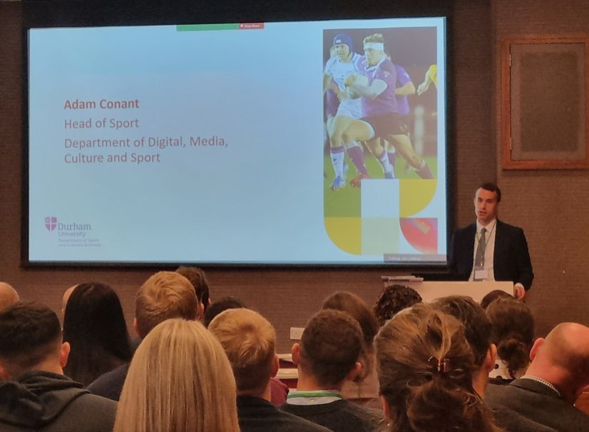 Man giving a presentation in front of an audience