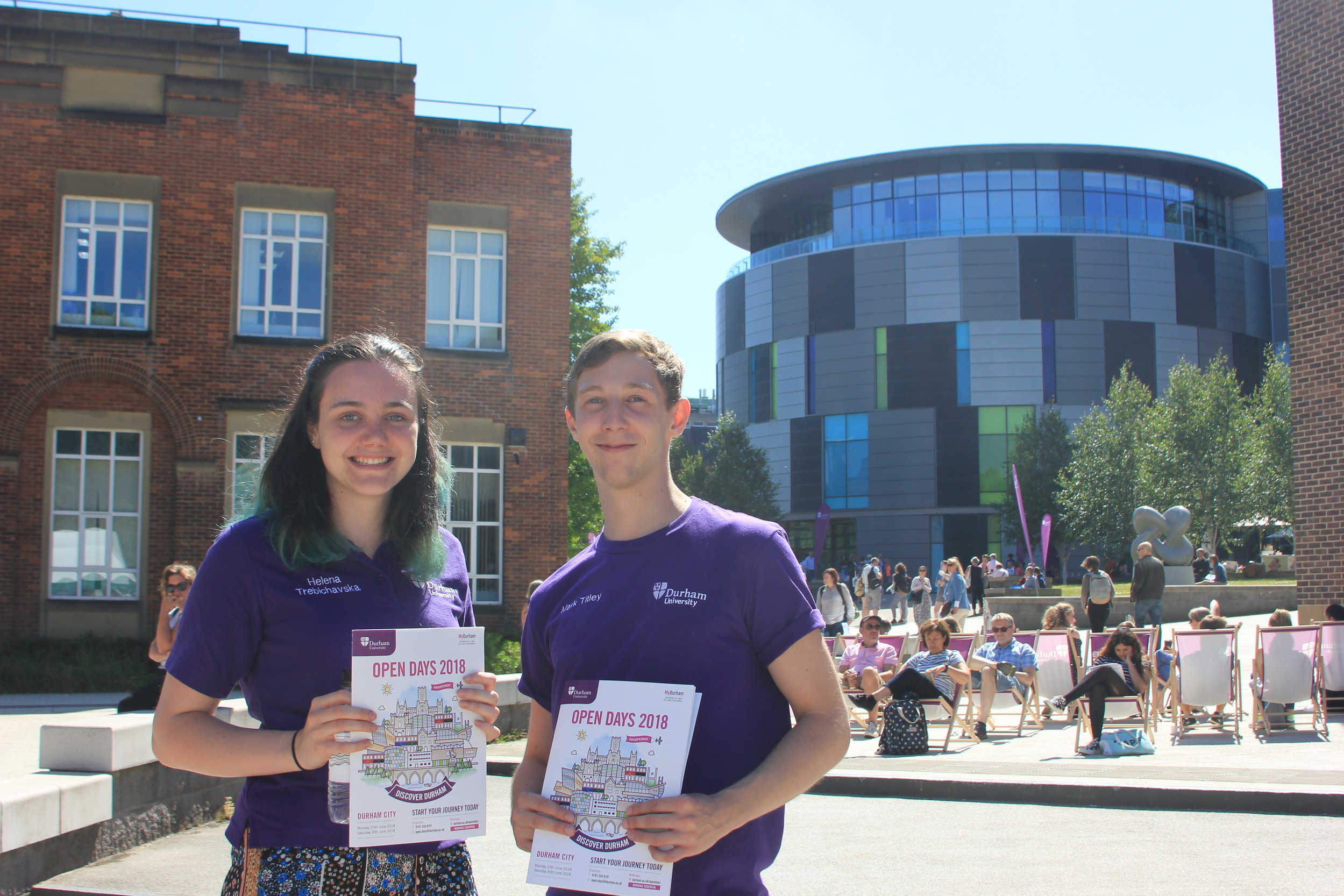 TTwo Durham students on campus with open day brochures