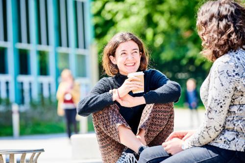 Two students talking on campus