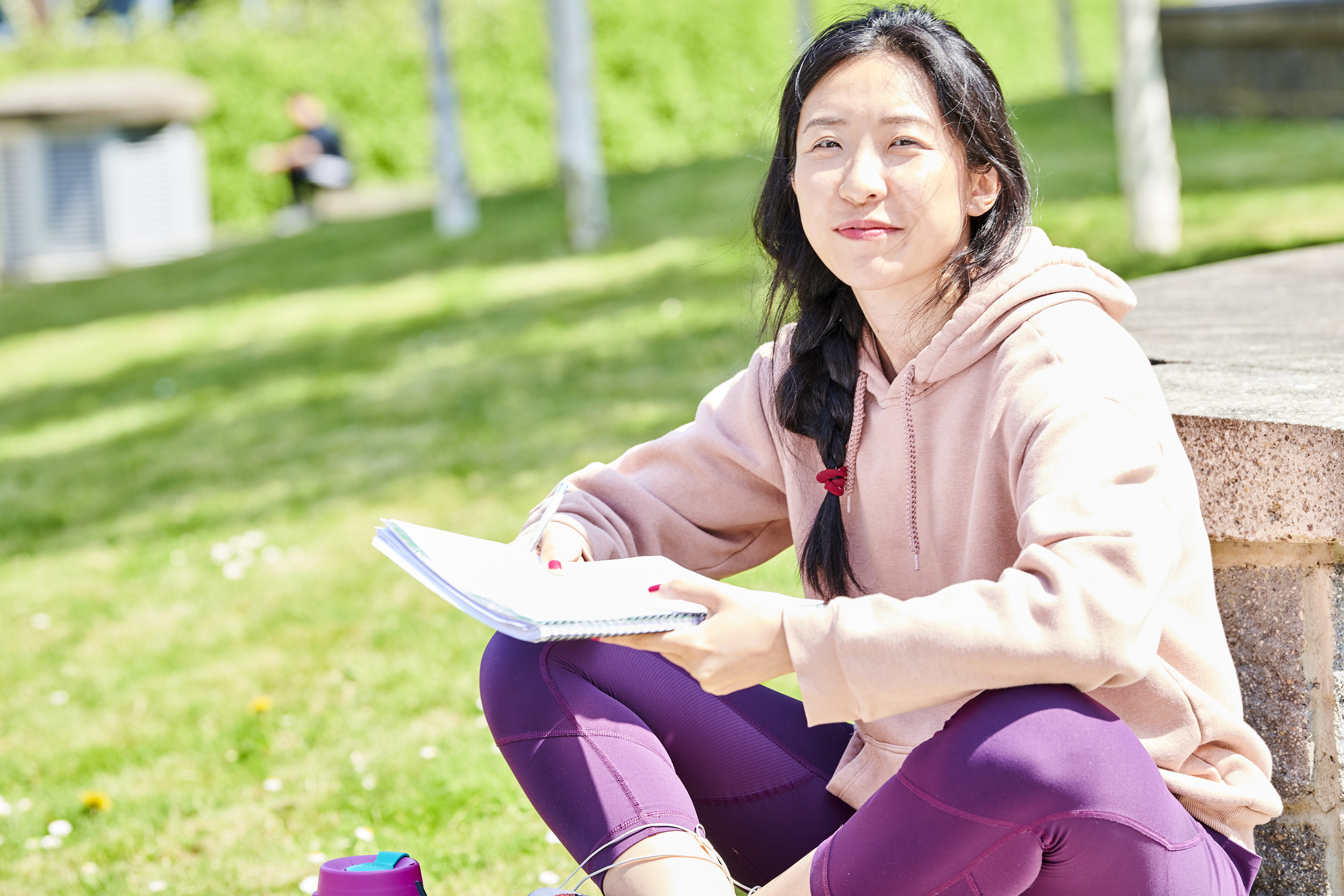 Student sat studying on campus