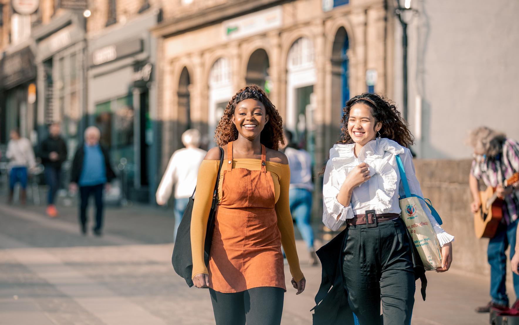 Two women in walking through Durham city centre