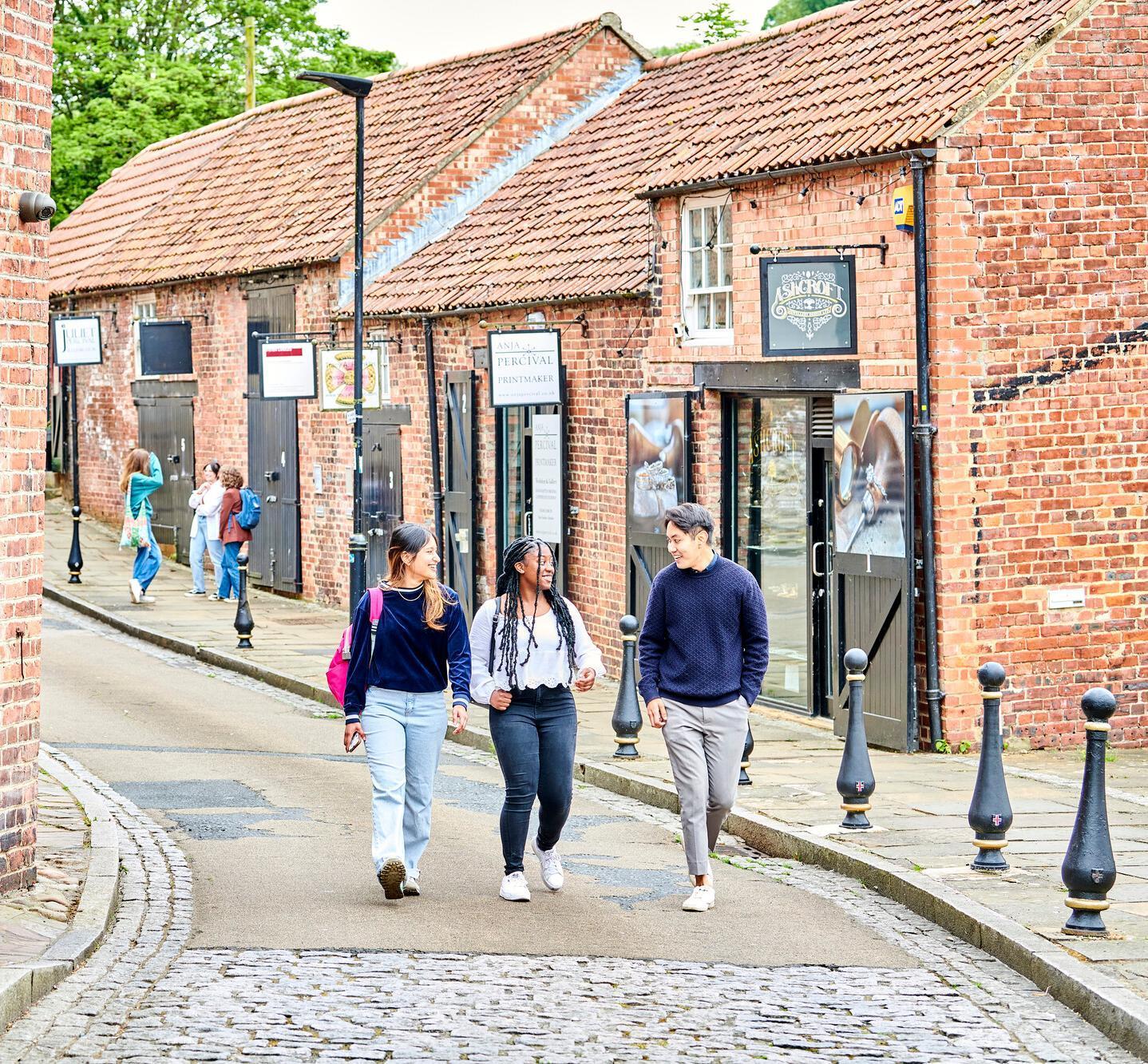 Students walking on a cobbled street