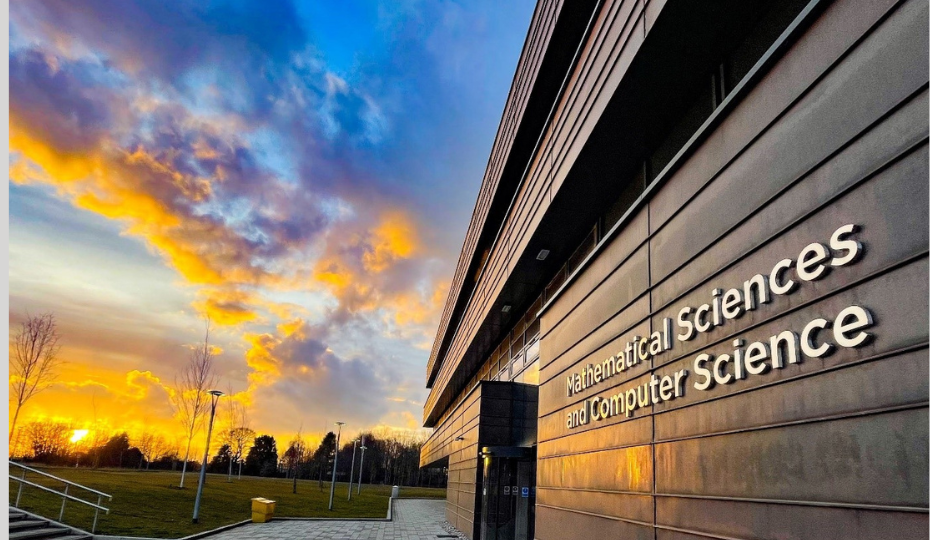 Outside the Mathematical Sciences and Computer Science Building with an orange and blue sky