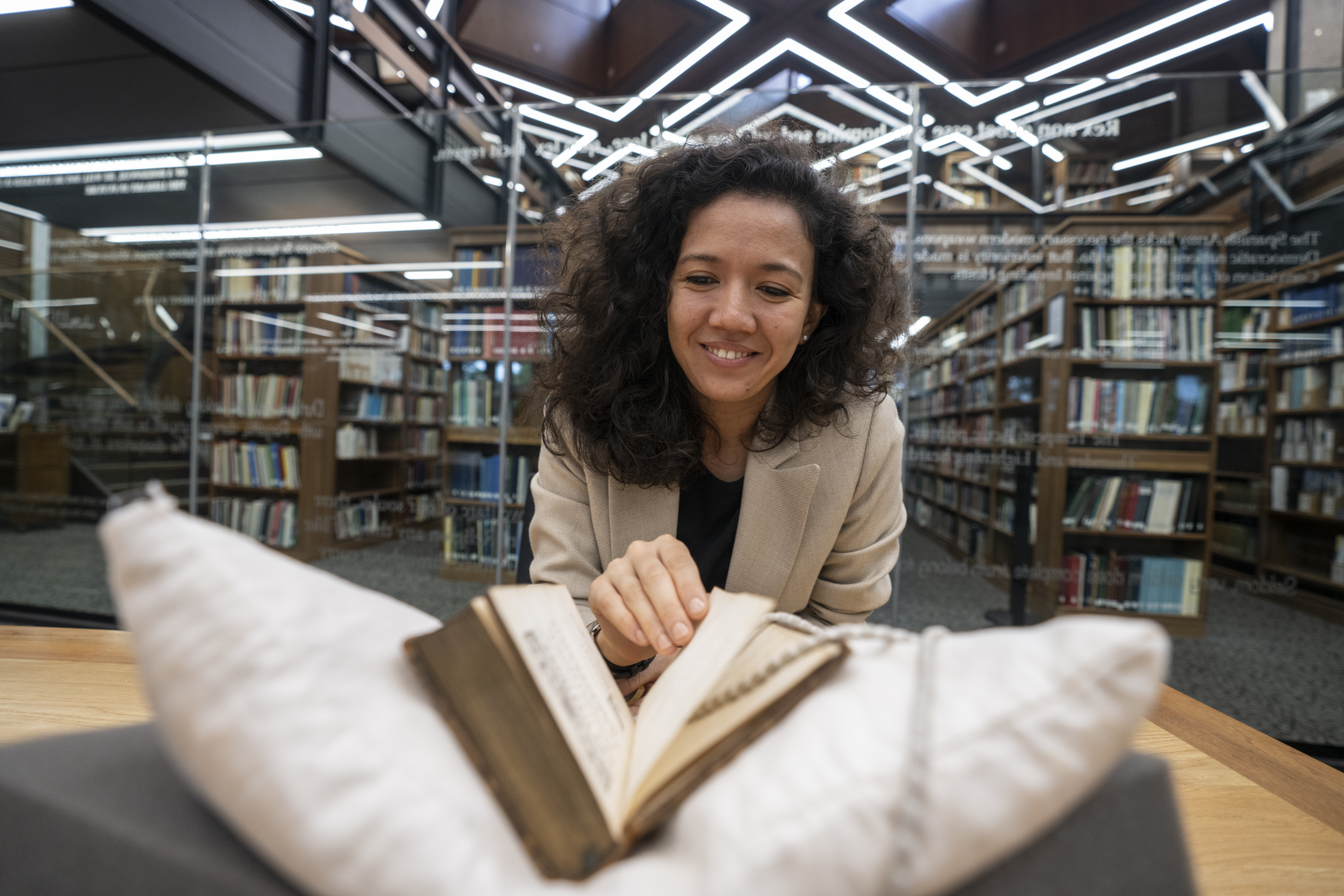 Female Student reading book in the barker Research Library Reading room