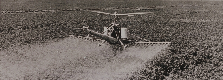 Helicopter spraying a field of cotton to control the jassid pest, Gezira Cotton Scheme, 1950s (D.M.H. Evans collection, SAD.711/2/4)