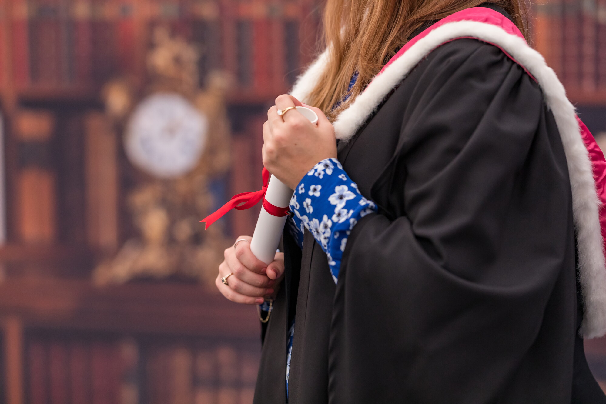 Student holding degree certificate prop