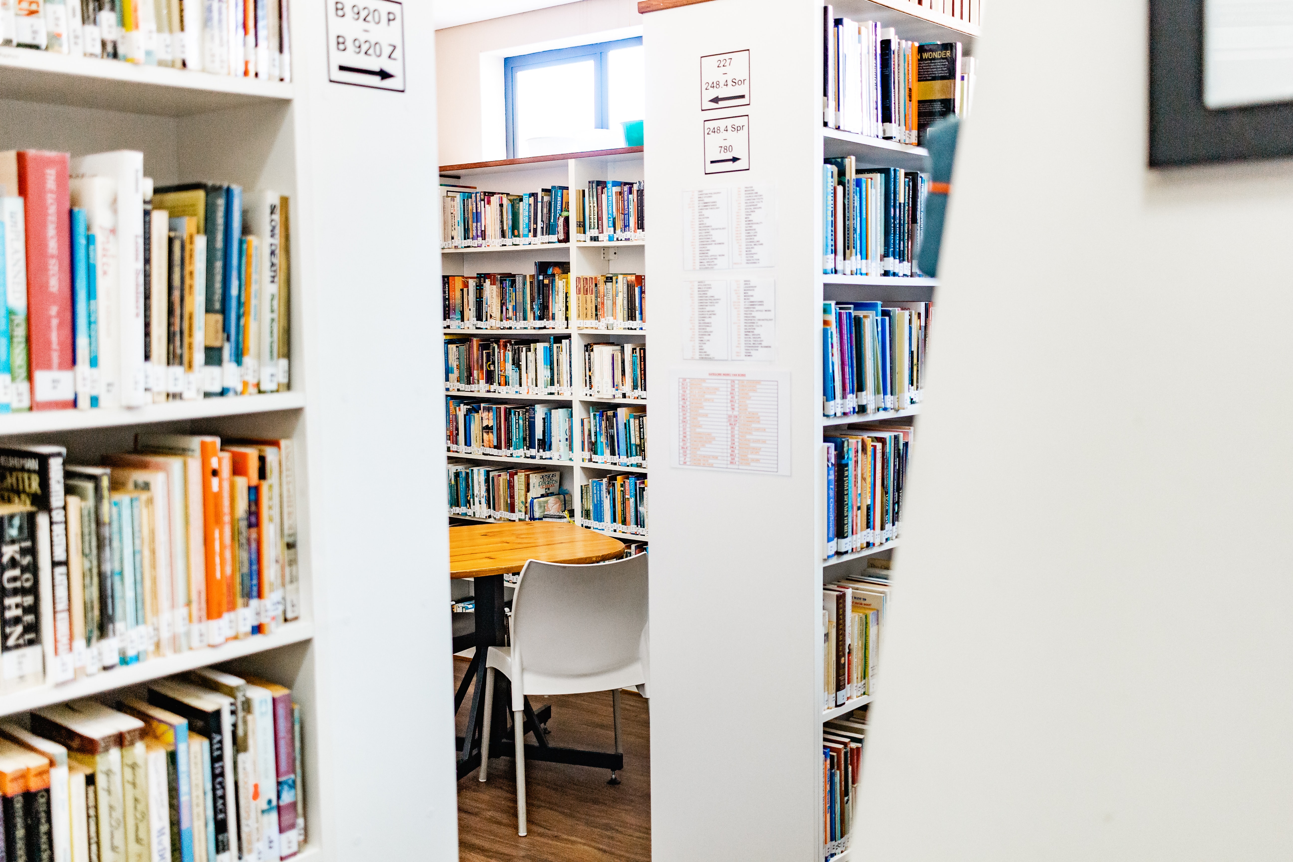 white wooden bookshelf with books