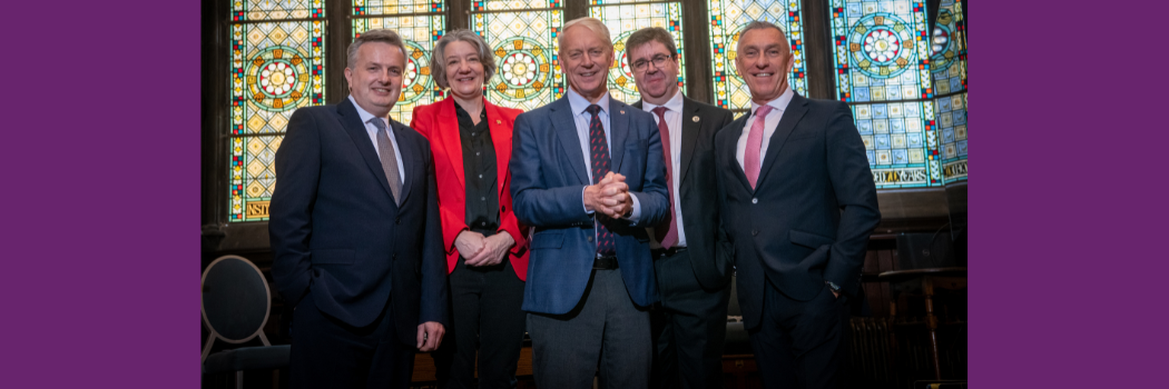 Representatives of the five North East universities stood in front of a stained glass wiindow