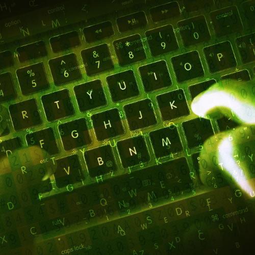 Hands typing on dark keyboard