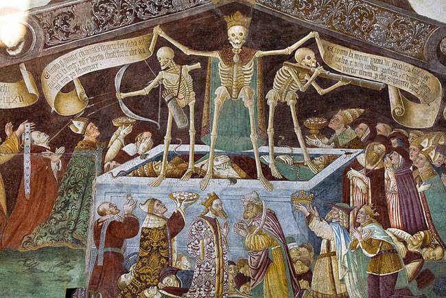 A photograph of The Triumph of Death medieval fresco by Giacomo Borlone de Burchis painted on the wall of Oratorio dei Disciplini Clusone, Italy