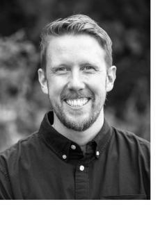 Black and white image of a man smiling