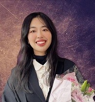 Woman smiling, holding flowers