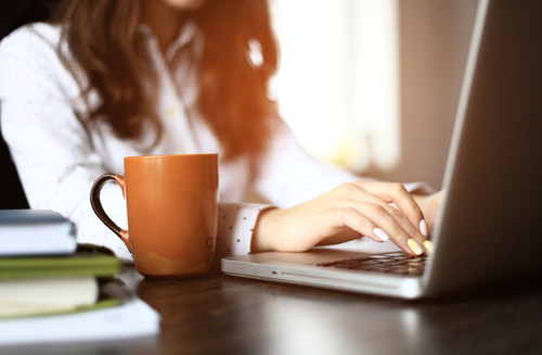 TFemale hands busy typing on a laptop