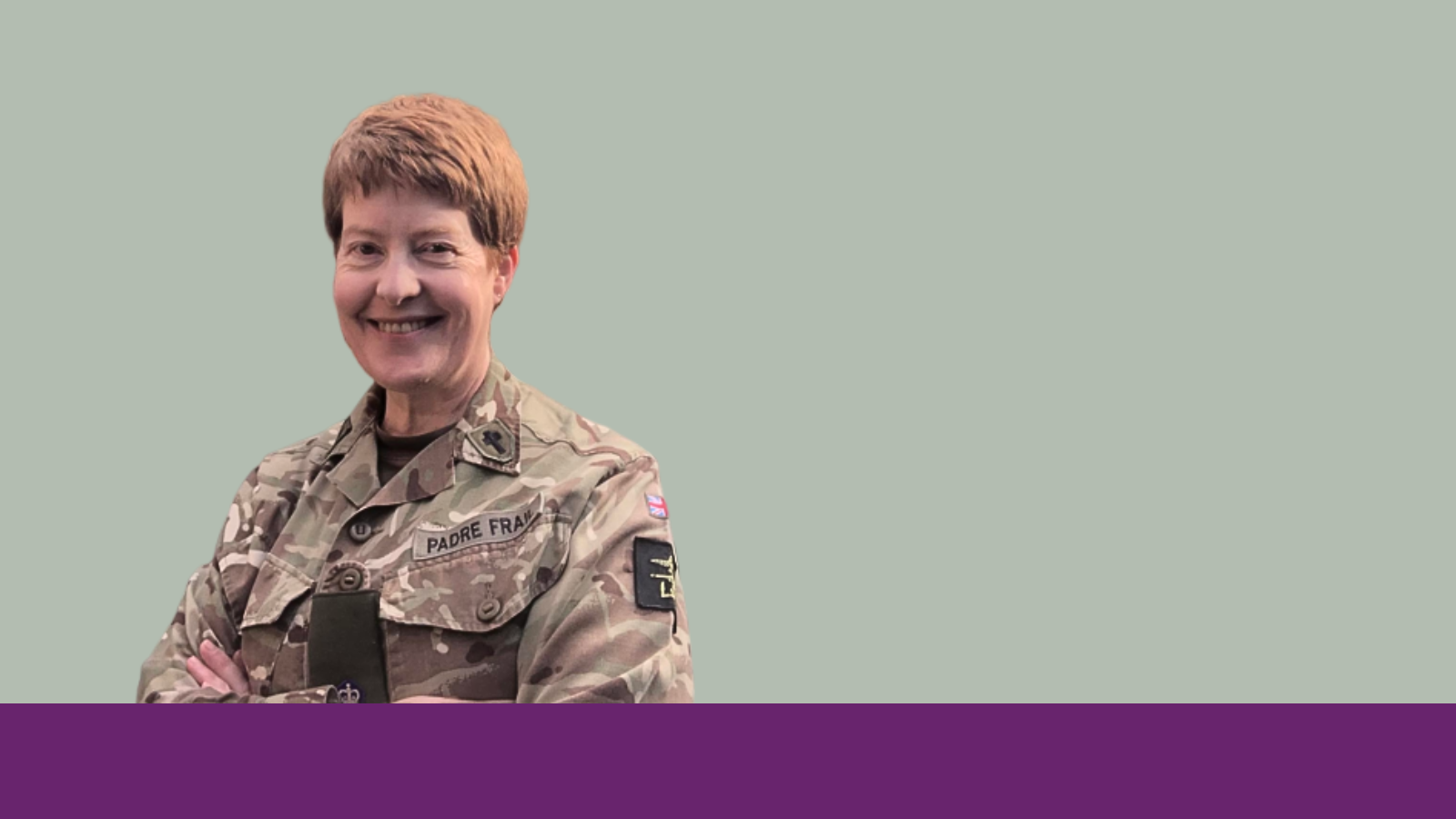 A smiling woman with short red hair wearing British Army combat uniform