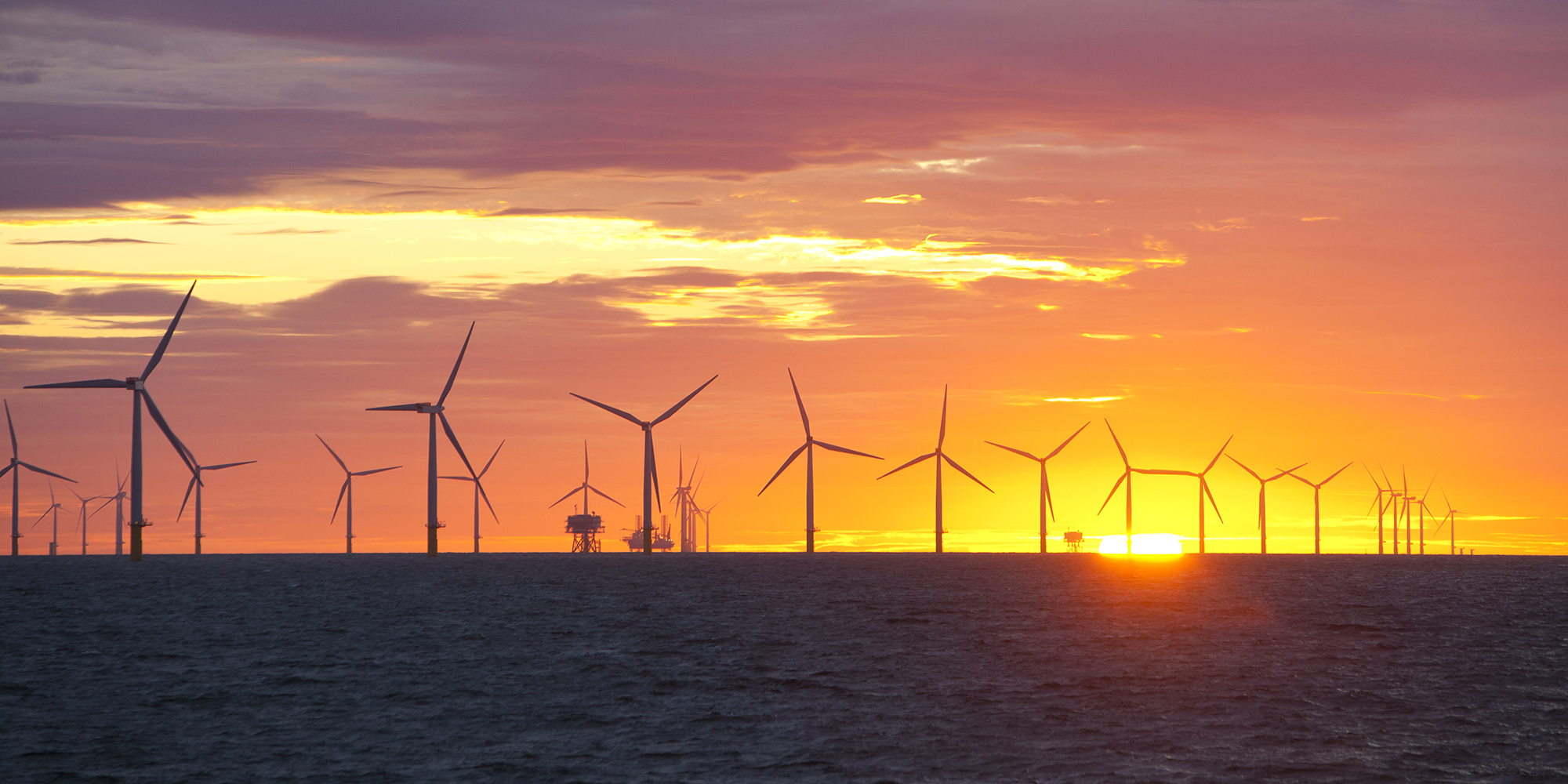 TSunset over an offshore wind farm