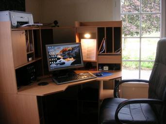 Image of a home office working space with desk and monitor