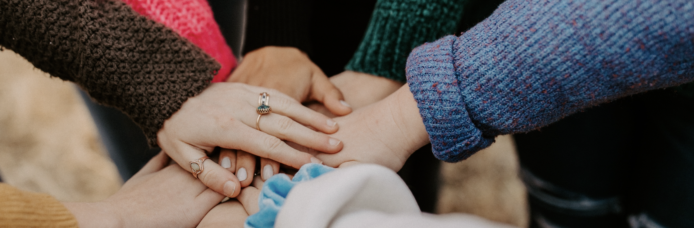 A group of hands together on top of each other