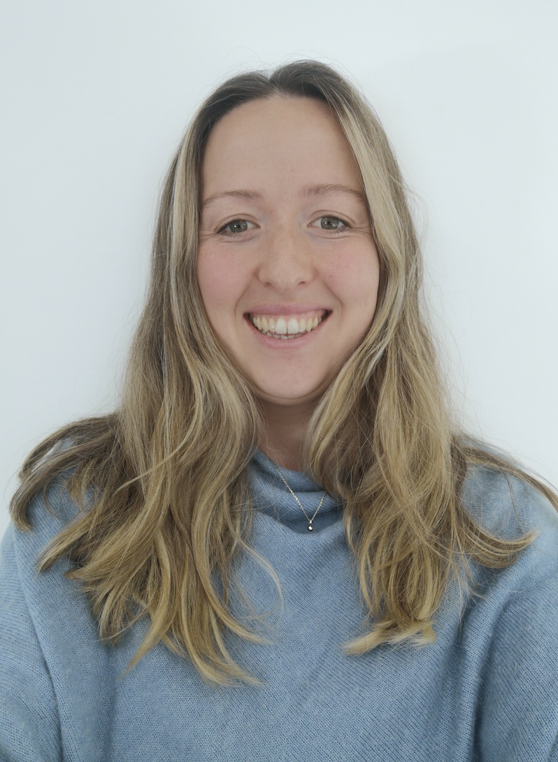 A smiling white woman with long blonde hair