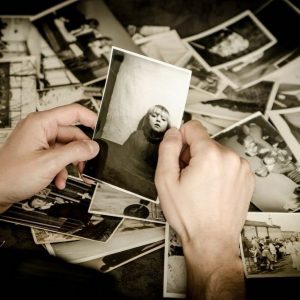 A pair of hands holding a black and white photo