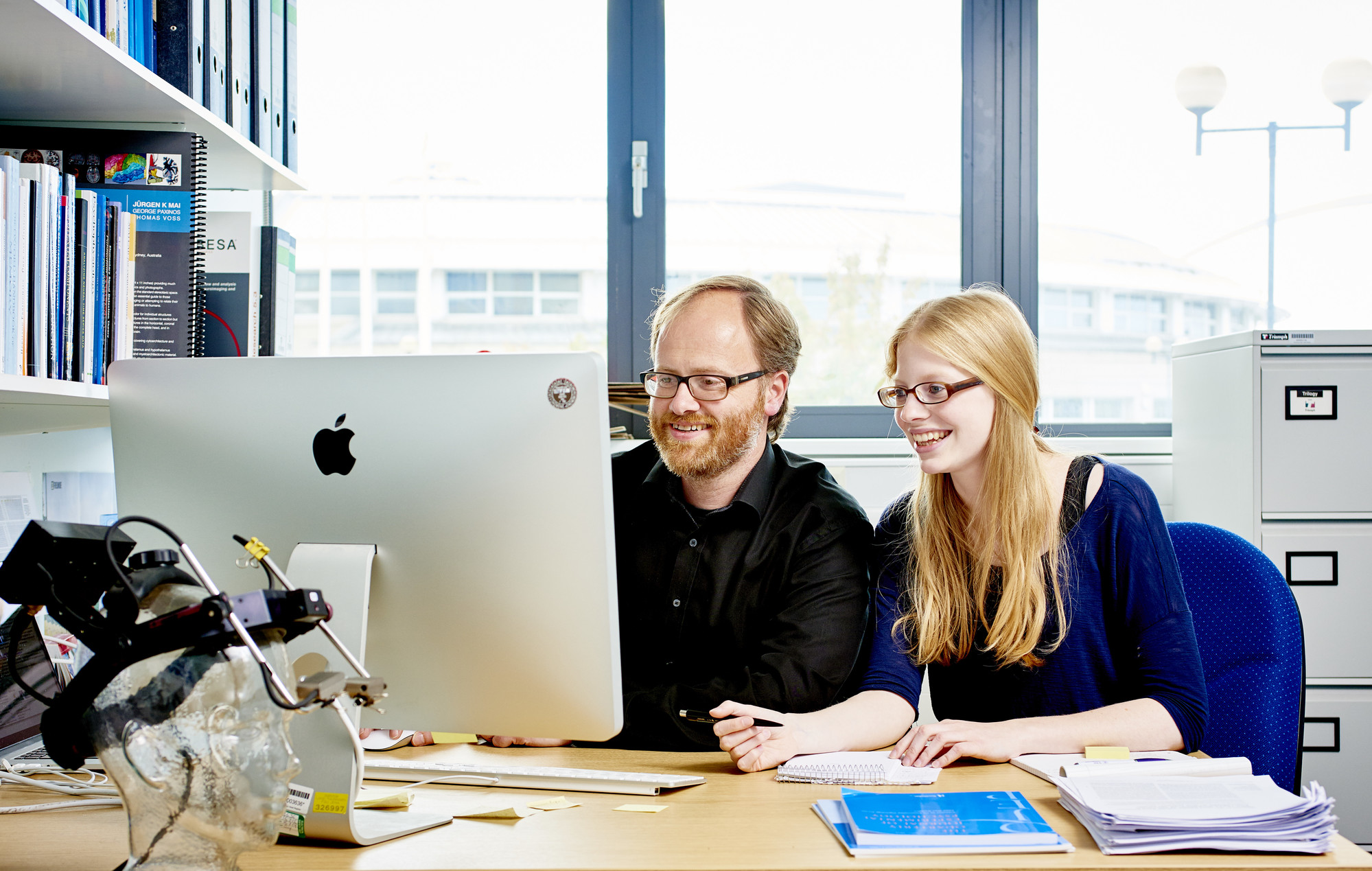 Two people looking at a computer