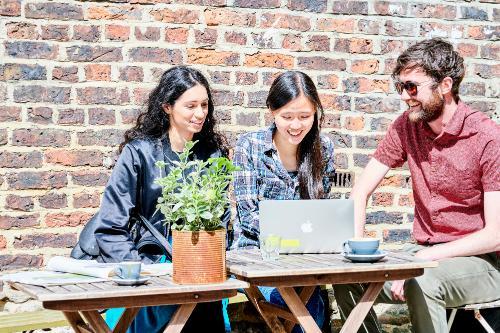 TStudents studying and drinking coffee outside