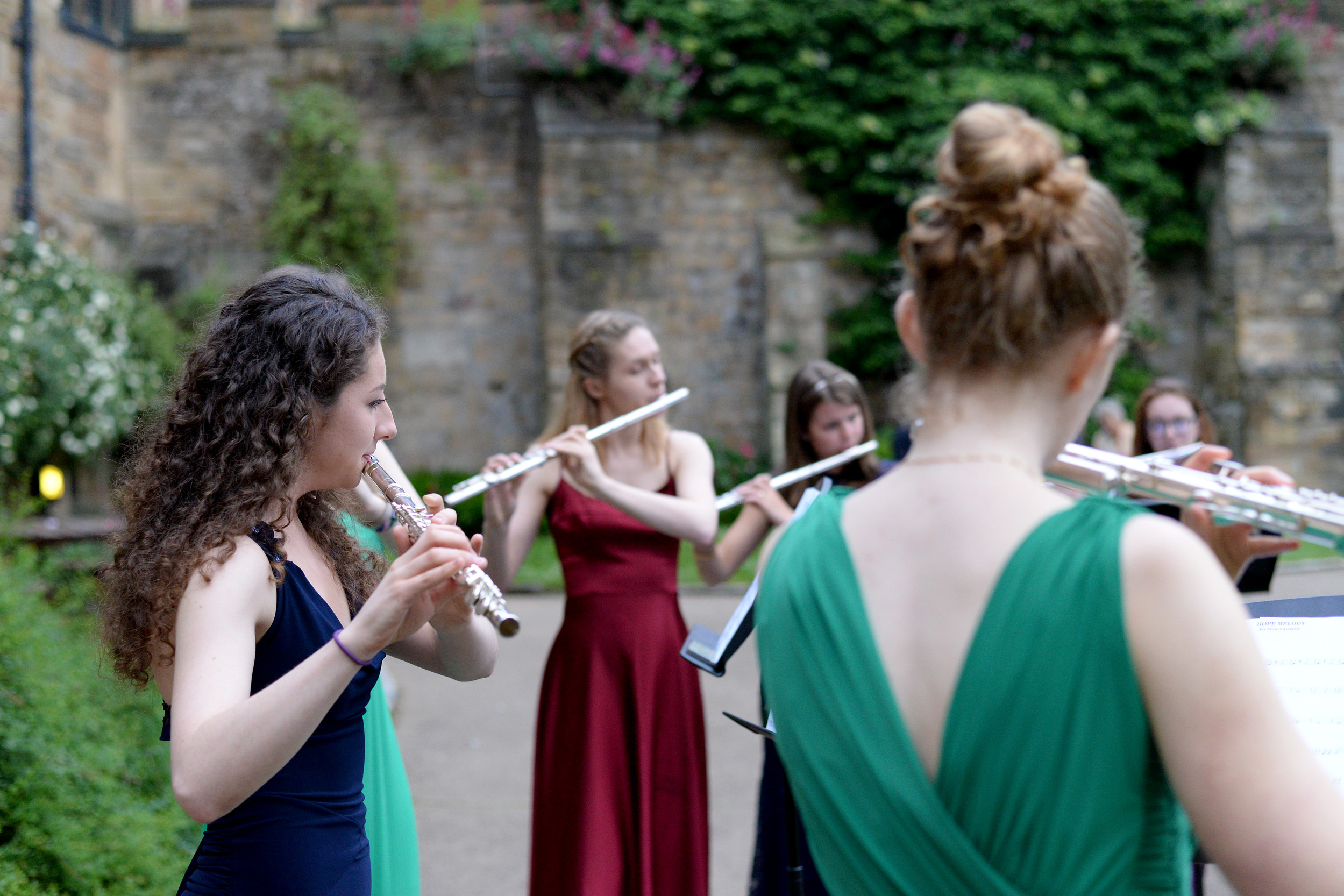 Group of flute players performing outside Durham Castle