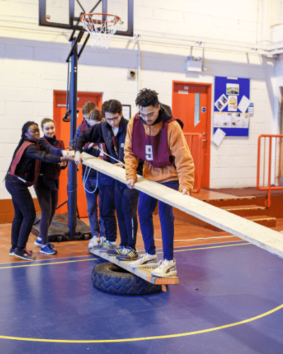 TGroup of students balancing holding a plank