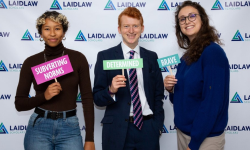 Three students holding Laidlaw messages