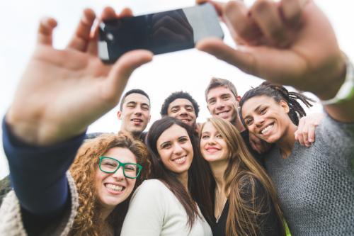 TSeveral people taking a selfie