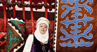Oriental Museum Silk Road Exhibition Oct 2022 Woman with coloured rugs