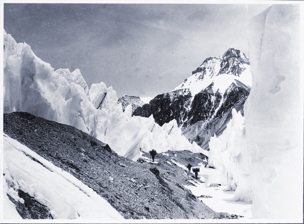 Climbers walk between mountain peaks