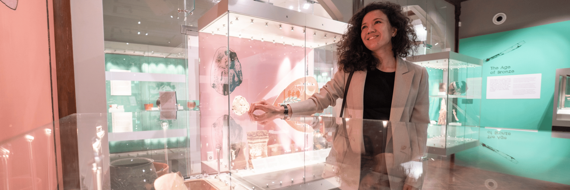 A woman examining an exhibit in the Museum of Archaeology