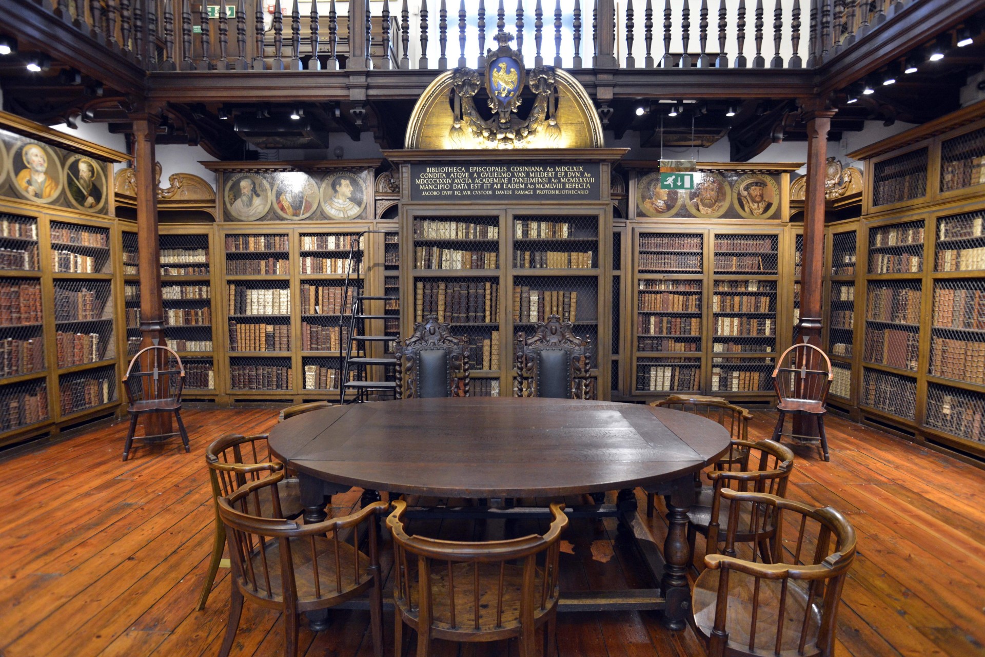 Cosin’s Library interior. A wooden table in front of large wooden bookcases filled with historic books.